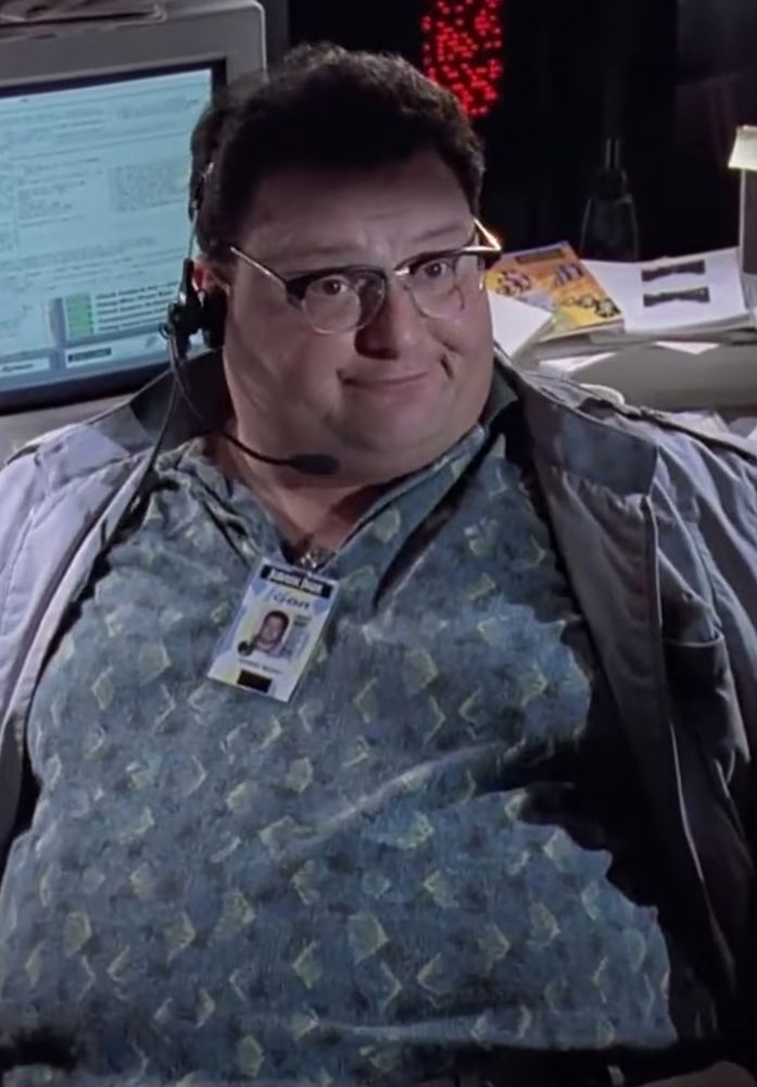 Dennis Nedry (Wayne Knight) was born in Lansing Michigan. As Nedry grew he would become a talented programmer. A still shot from Jurassic Park. 