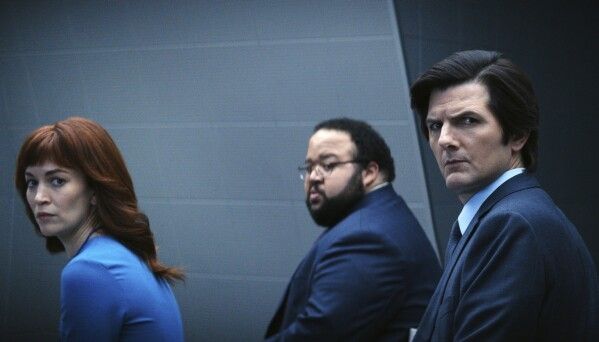Helly R. (Britt Lower), Dylan G. (Zach Cherry), and Mark S. (Adam Scott) in a scene from "Severance." (Jon Pack/Apple TV+ via AP)