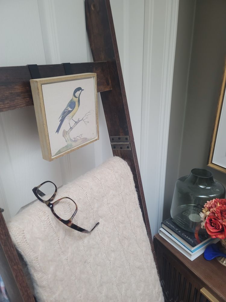 Reading glasses precariously perched on a blanket ladder in the upstairs hallway. 