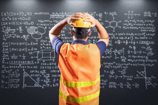 Construction worker looks at complex equations and appears to not comprehend.