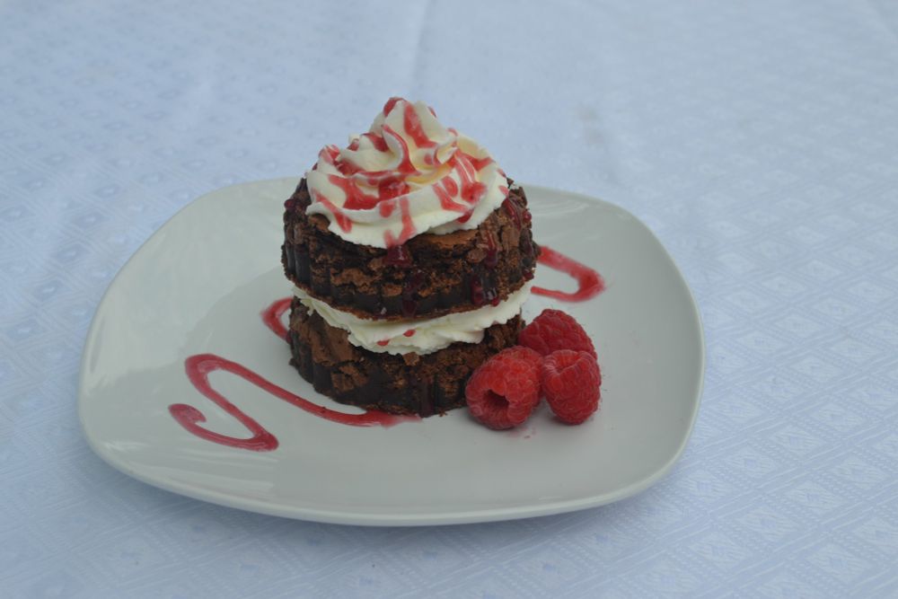 Brownie with stabilized whipped cream and raspberry sauce!