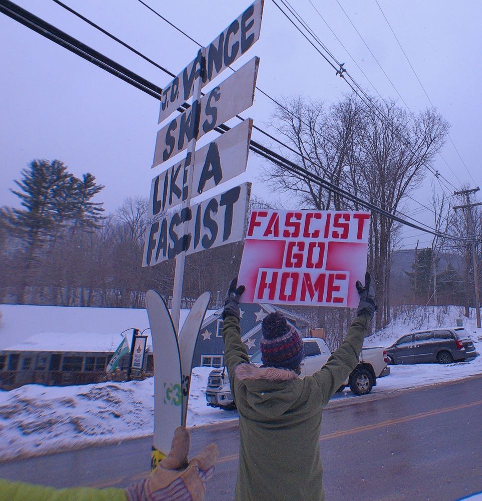 Vermont protest signs read: "JD Vance skis like a fascist" and "fascist go home."