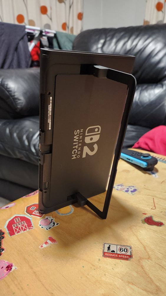 Switch 2 console with the kickstand used to prop it up vertically
