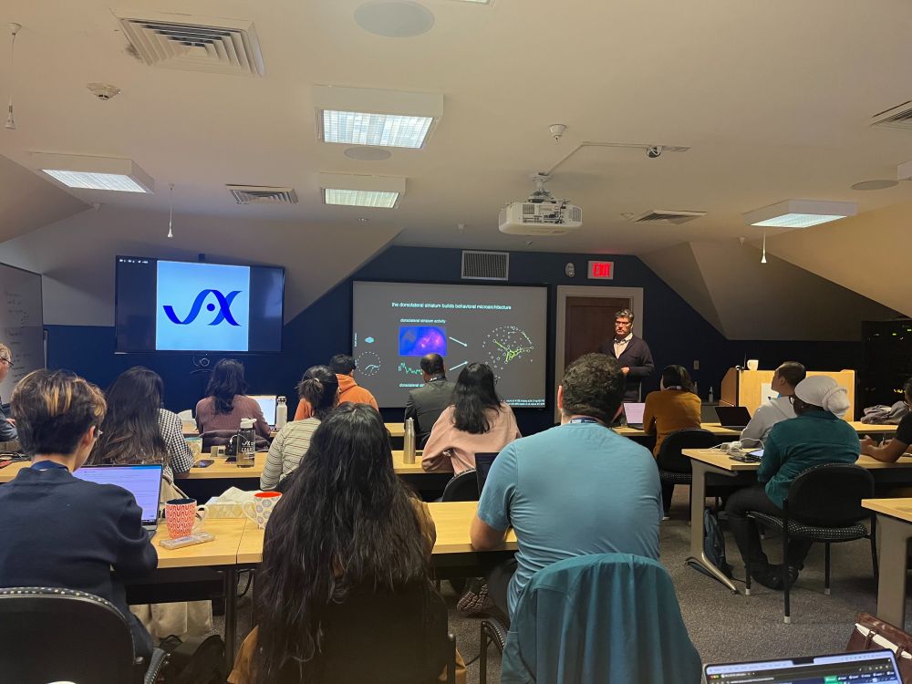 Participants of the Machine Learning Short Course seated at tables in The Jackson Laboratory's High Seas conference center classroom with a speaker behind the podium.