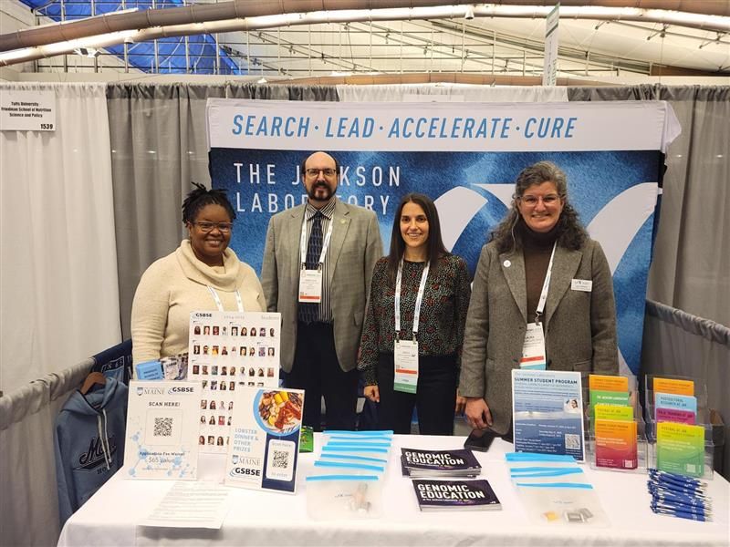 Members of the Genomic Education team stand together with Greg Cox, Ph.D., at The Jackson Laboratory's booth at ABRCMS 2024.