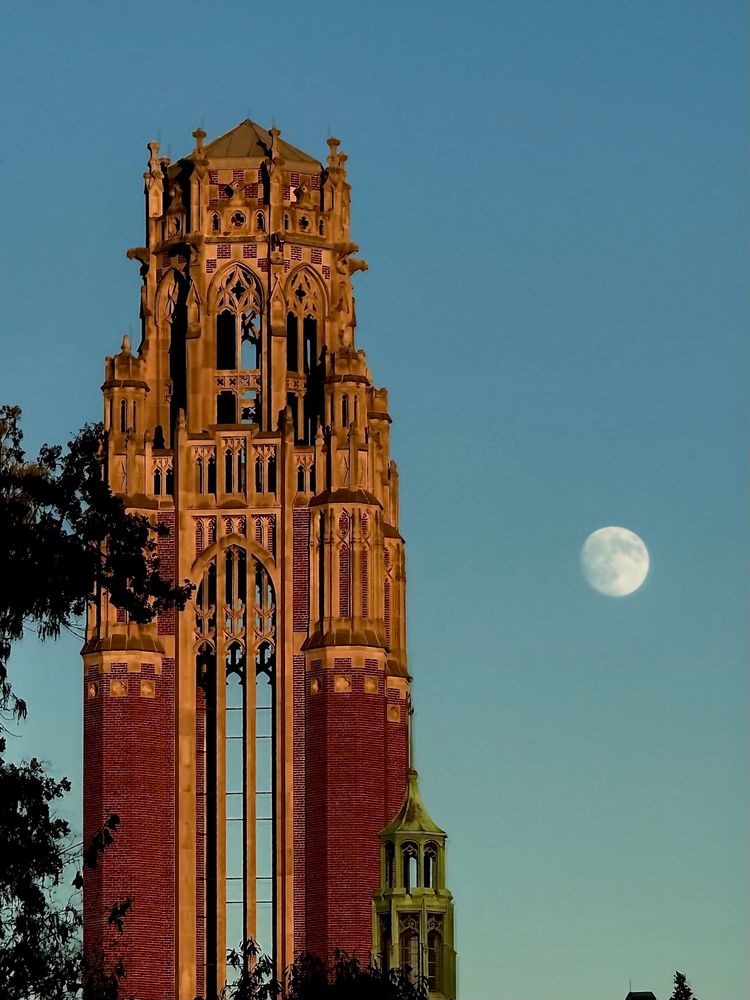The moon nearing fullness beside the Theological Seminary Tower at the University of Chicago