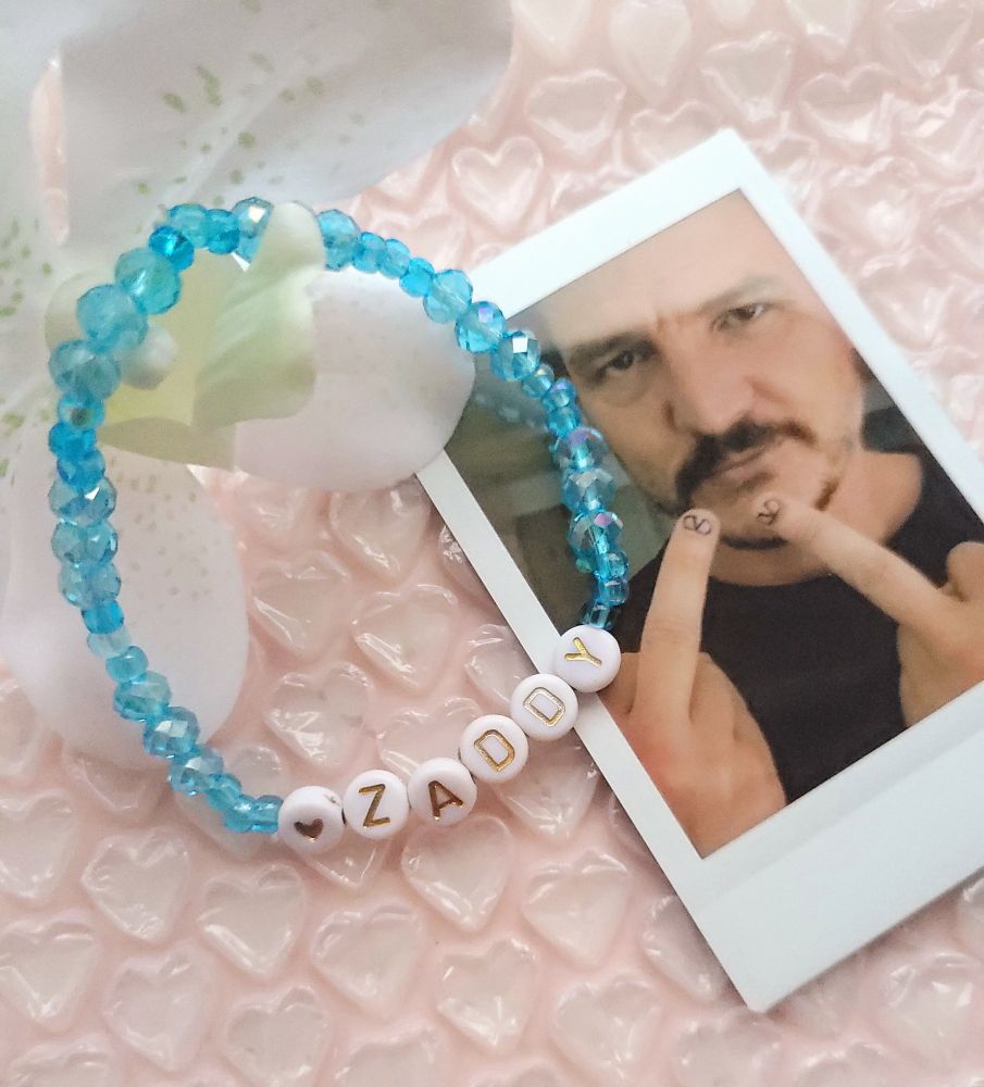 Handmade beaded bracelet featuring glass seed beads and rondelle beads with acrylic letter beads that says ♡ zaddy