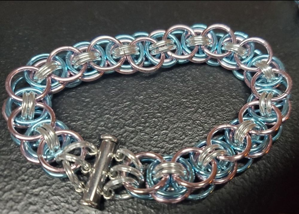 A pink, blue, and silver chainmaille bracelet to show off trans colors.