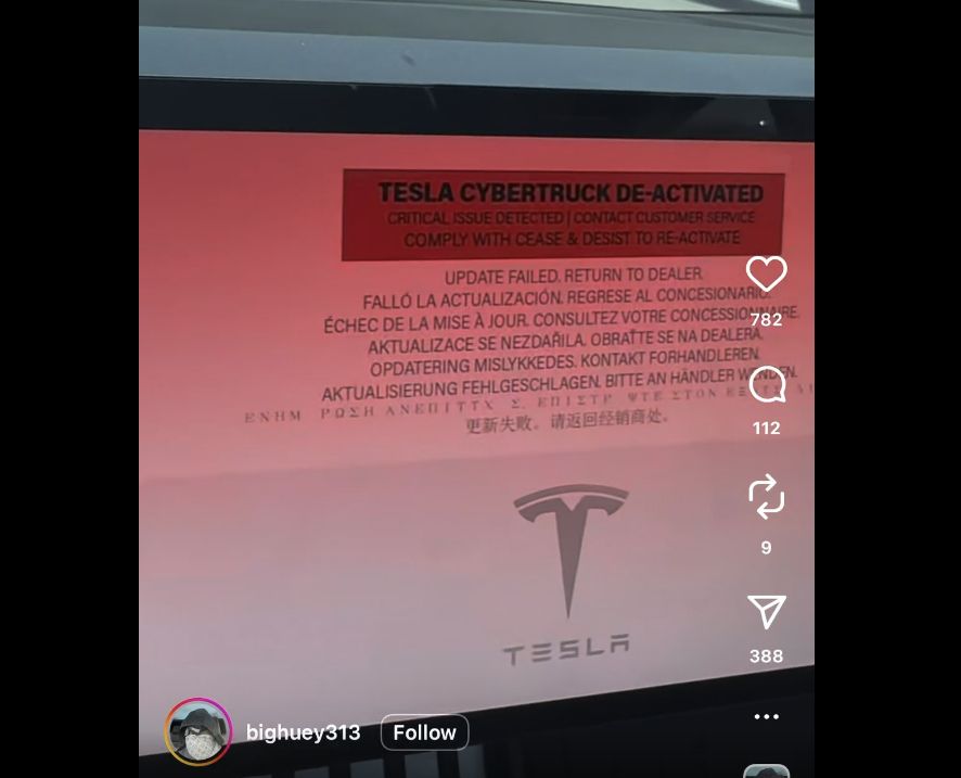 A flashing red screen on the Cybertruck shows the Tesla logo and says 