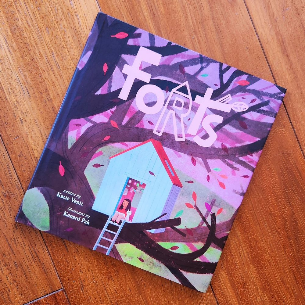 Cover of the picture book FORTS, written by Katie Venit and illustrated by Kenard Pak, showing a young girl sitting in a cozy treehouse fort