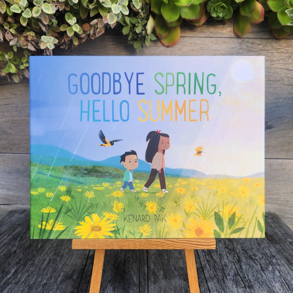 A picture book - GOODBYE SPRING, HELLO SUMMER by Kenard Park - is displayed on a small wooden easel