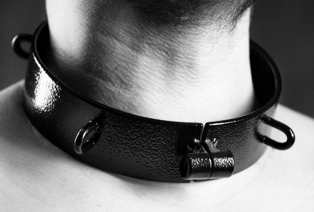 A steel collar, securely bolted around the neck of a slave