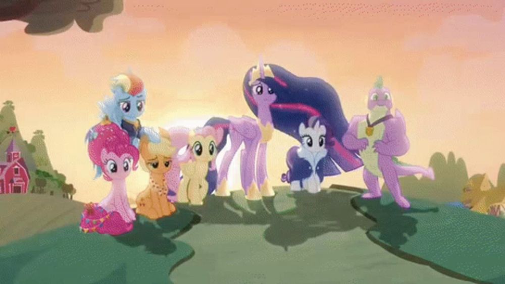 a group of ponies standing on top of a hill with a red barn in the background