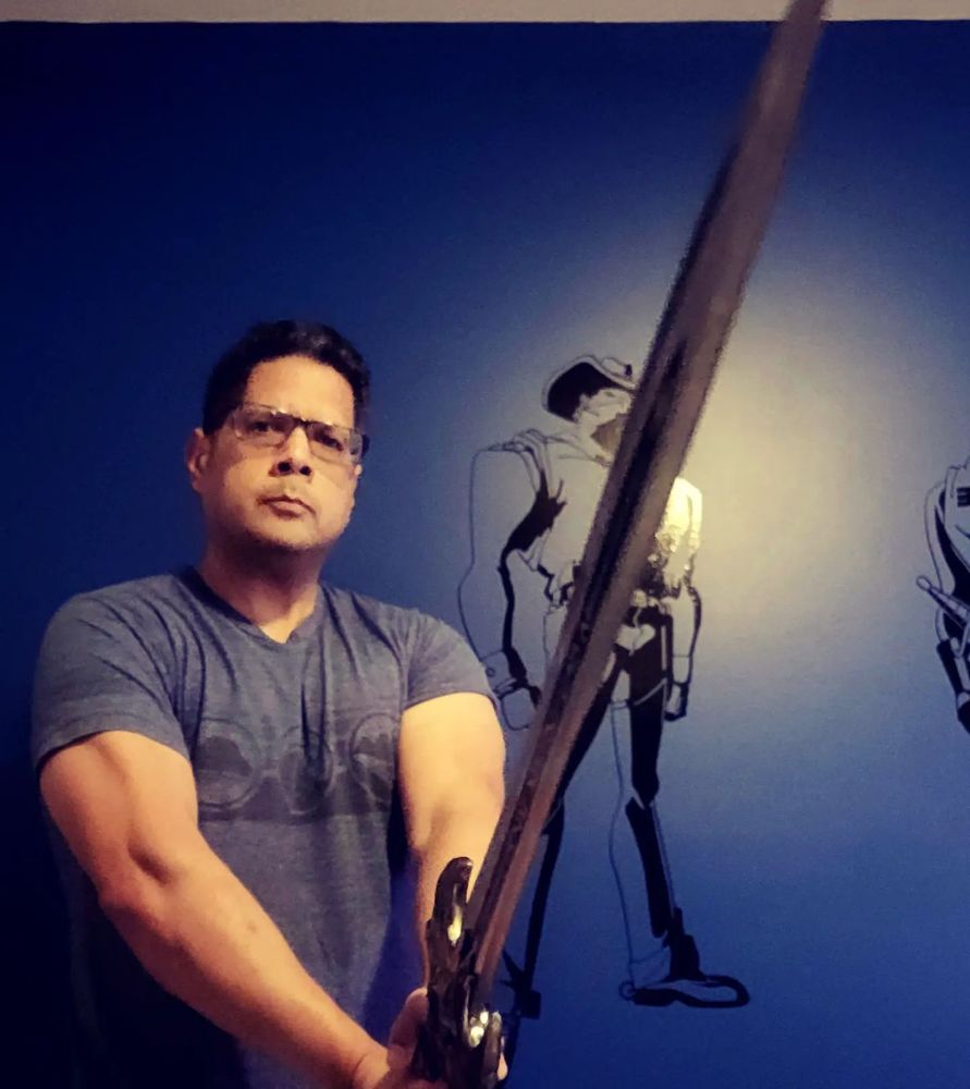 Me holding the anniversary sword from Warcraft from Blizzard.