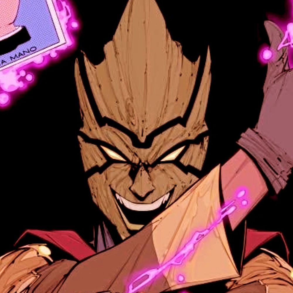 A close up of the creepy wooden jester mask of the Villain Loteria while cards featuring classic imagery of the Loteria game hover around him with energy.  BUT IN COLOR!