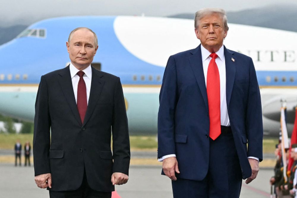 US President Donald Trump and Russian President Vladimir Putin pose on a podium on the tarmac after arrival at Joint Base Elmendorf-Richardson in Anchorage, Alaska, on August 15, 2025. Putin is in...