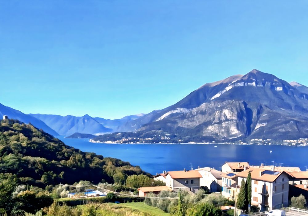 Scenic village on Lake Como with mountains in the background. 