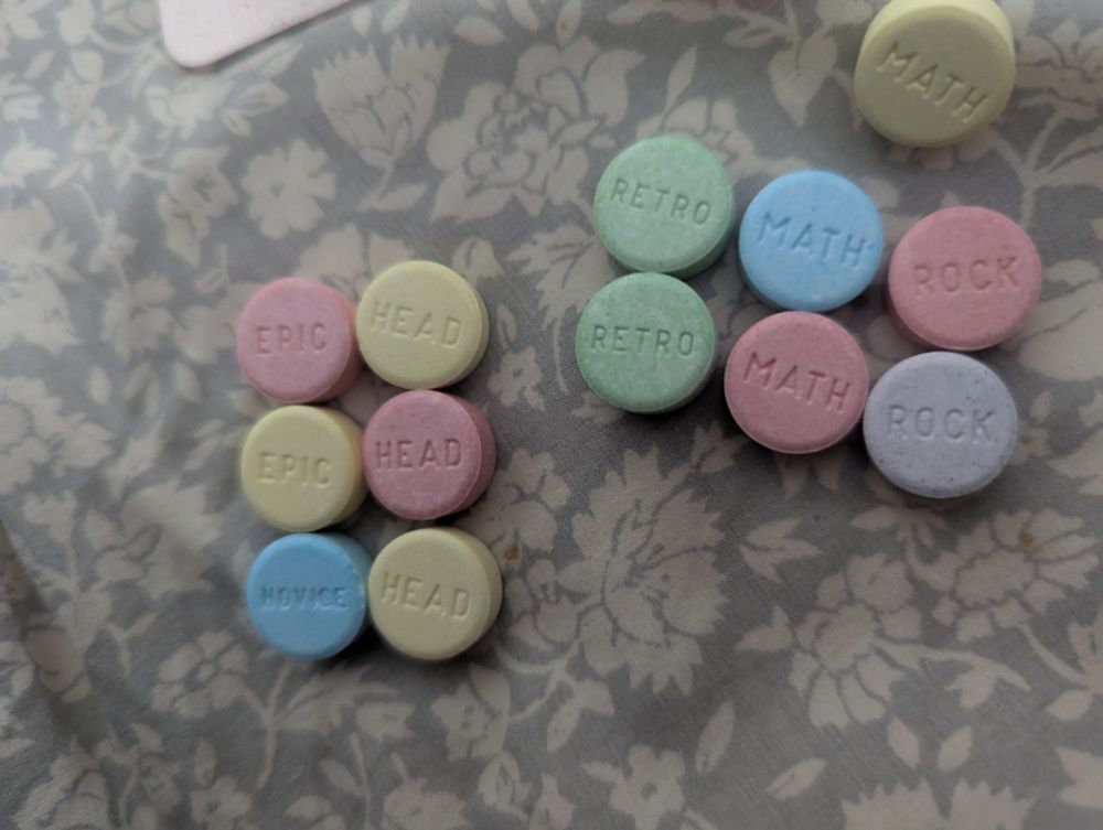 Valentine's Day SweetTarts arranged immaturely. One set says "retro math rock" in reference to one of my favorite compositional styles, and the other set says "epic head, epic head, novice head" because I am a child and I find it funny.