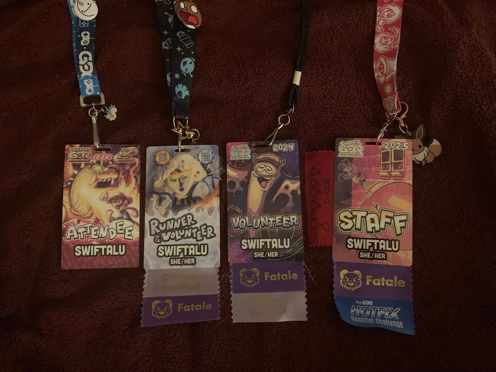 Different GDQ badges from various events, from right to left; AGDQ 2020 attendee, SGDQ 2023 runner & volunteer, SGDQ 2024 volunteer, SGDQ 2025 staff. All badges have the username Swiftalu under it