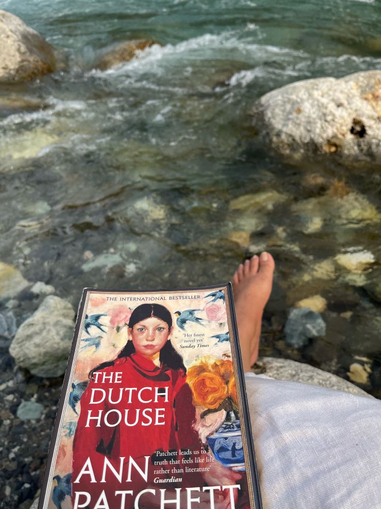 By the Tirthan river with a book