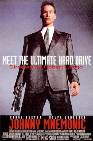 Johnny Mnemonic film poster showing Keanu Reeves in a charcoal suit holding a futuristic sawed-off shotgun