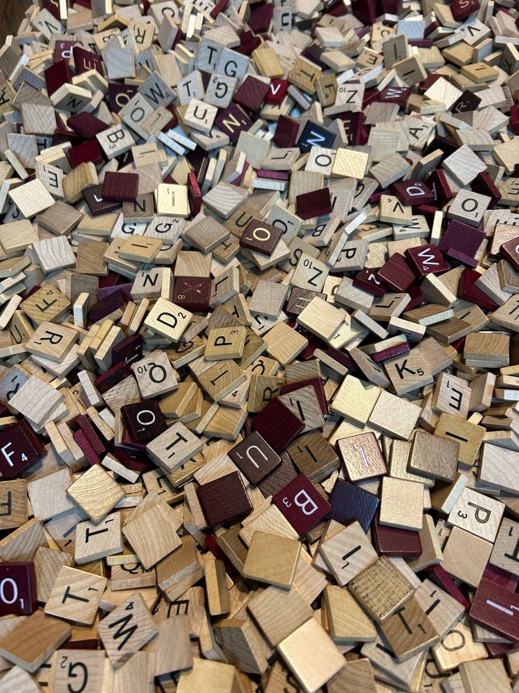 A sea of proper wooden scrabble tiles. Some are mahogany but most are classic pine. There must be hundreds in the picture 