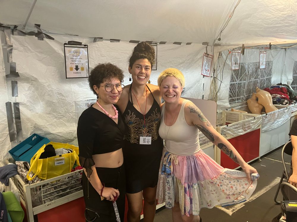 Op poses with two other volunteers during RePlace’s Big Night Out. All are smiling/laughing and OPs eyes are closed accidentally 