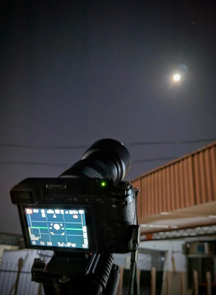 Camera with a telephoto lens point at the moon