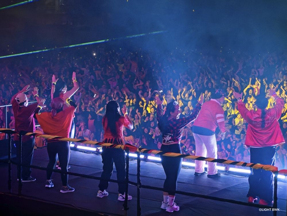 back view of the Zumba instructors, standing on stage, guiding the thousands zumba participents