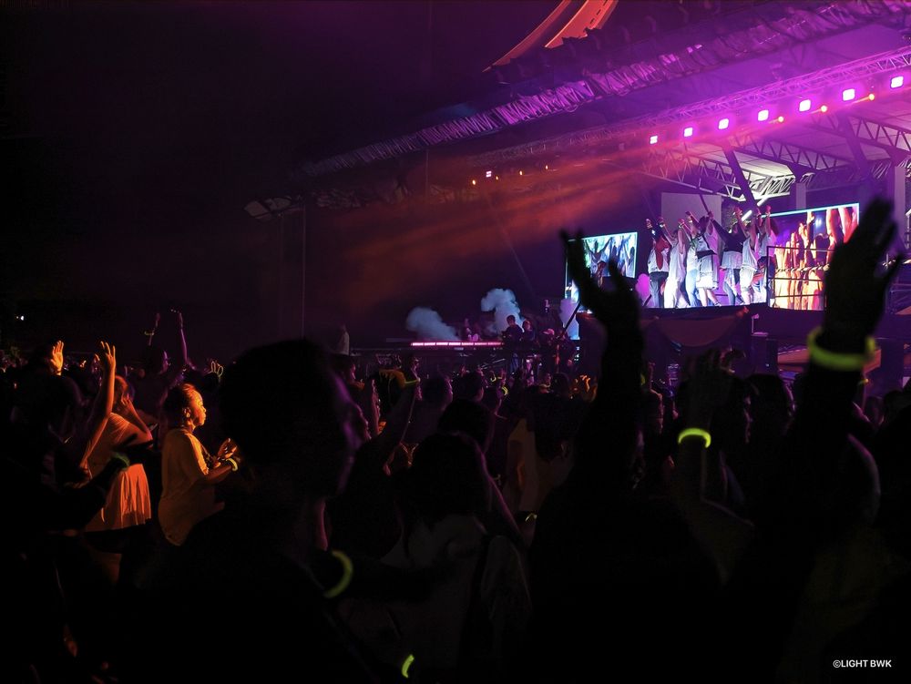 participants going wild and rising hands toward the stage