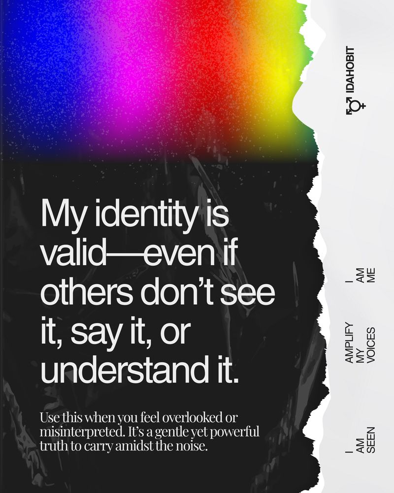 A torn-paper poster with a vivid rainbow gradient and black background features the text: “My identity is valid—even if others don’t see it, say it, or understand it.” On the right edge, vertical text reads “IDAHOBIT,” “I AM ME,” “AMPLIFY MY VOICES,” and “I AM SEEN.” The caption encourages using this mantra when feeling overlooked or misinterpreted.

