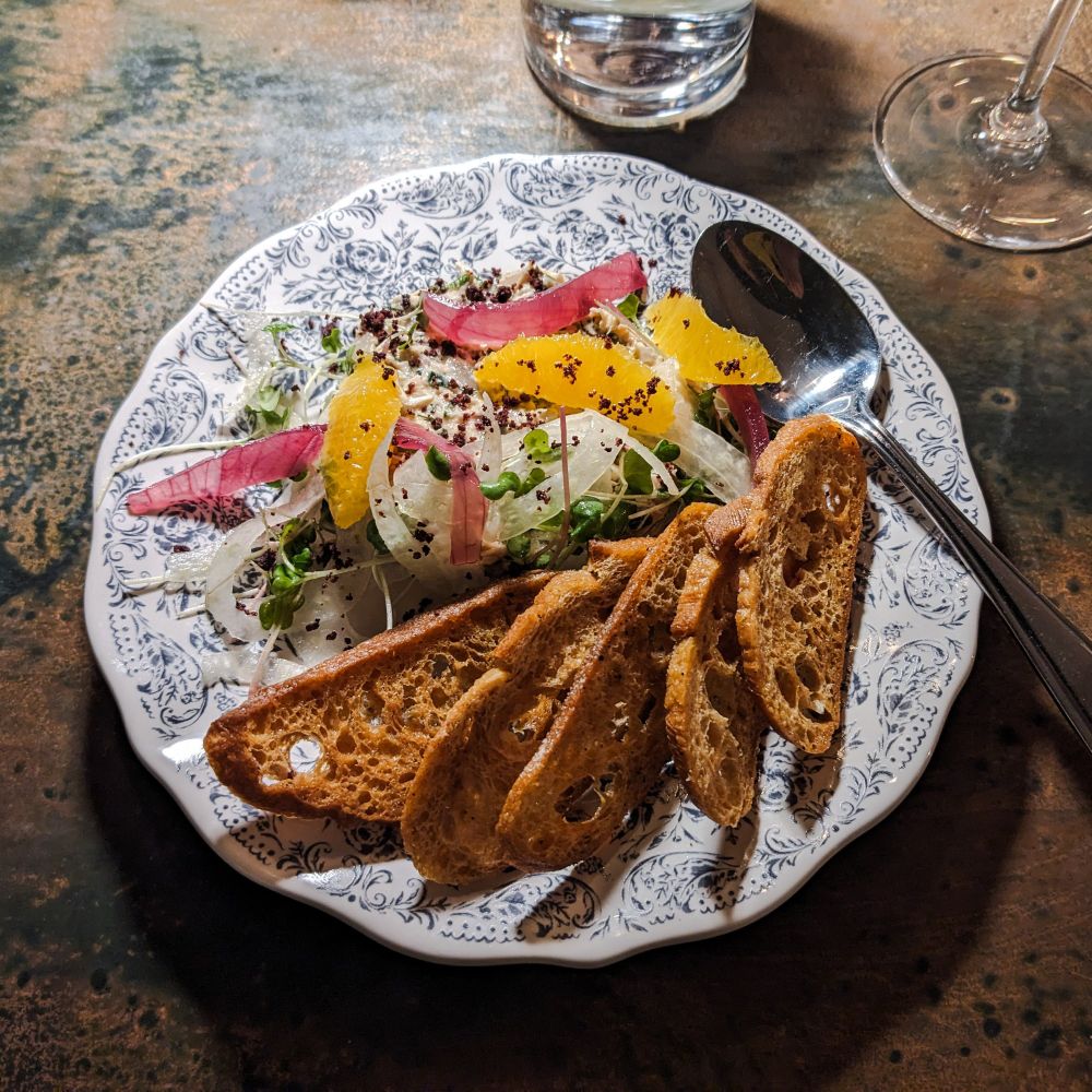 Salmon rillettes with fennel and orange slices.