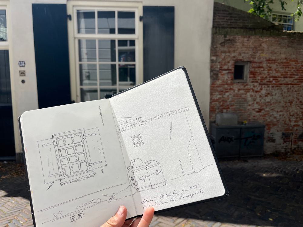 Photo of my sketchbook in front of the house 