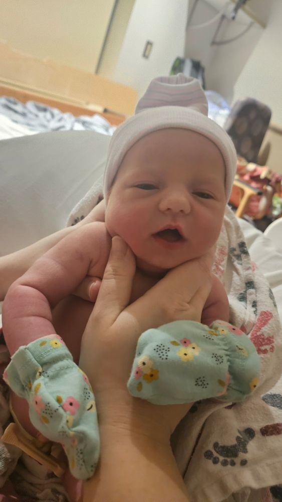Beautiful newborn Millie with her little hat and mittens