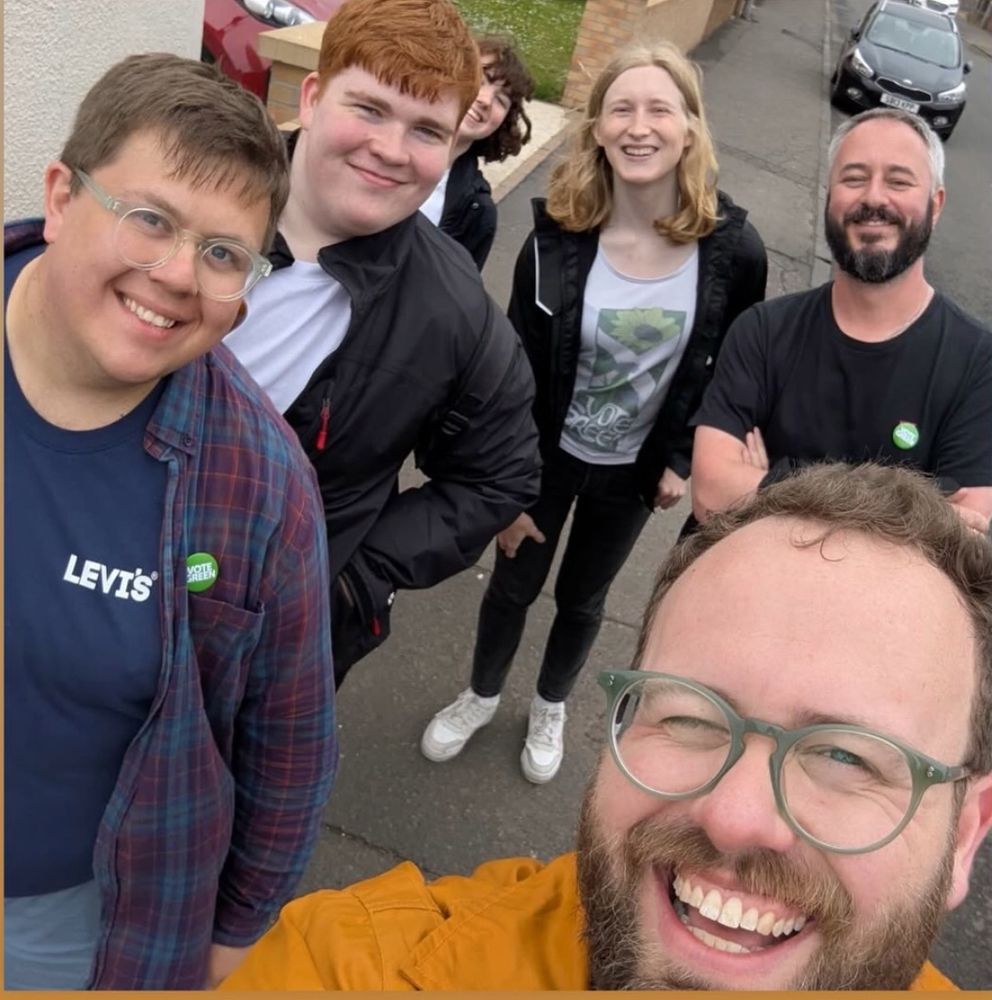 A bunch of activists looking glad to have just finished an afternoon of door knocking. 
