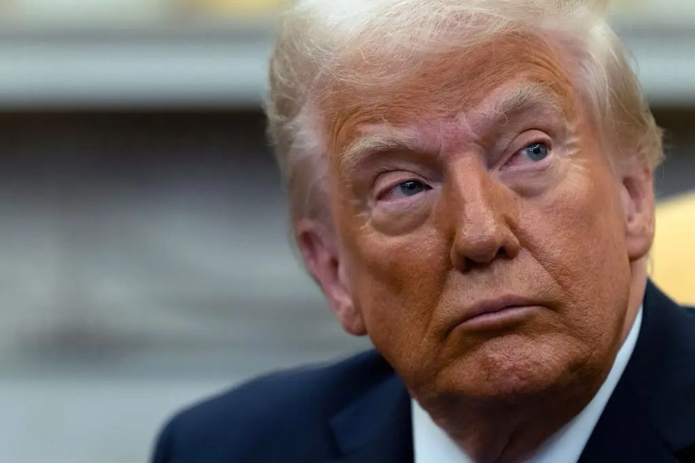 Elderly man with a combover wearing copious amounts of makeup.