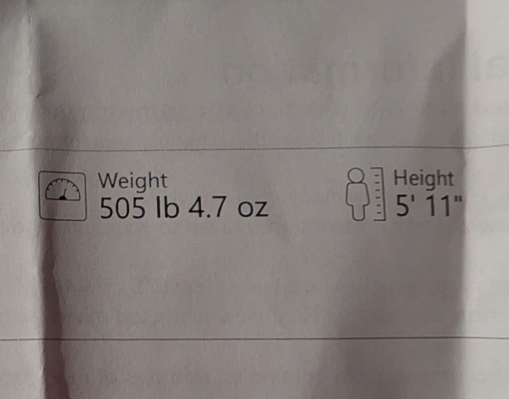 A slip of paper showing the weight 505 lb 4.7 oz and hight being 5'11"