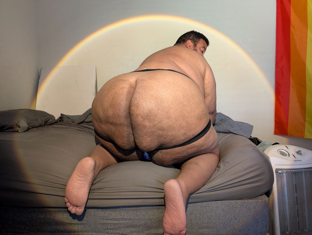 Superchub wearing a jockstrap bent over on all fours on his bed showing off his massive butt cheeks