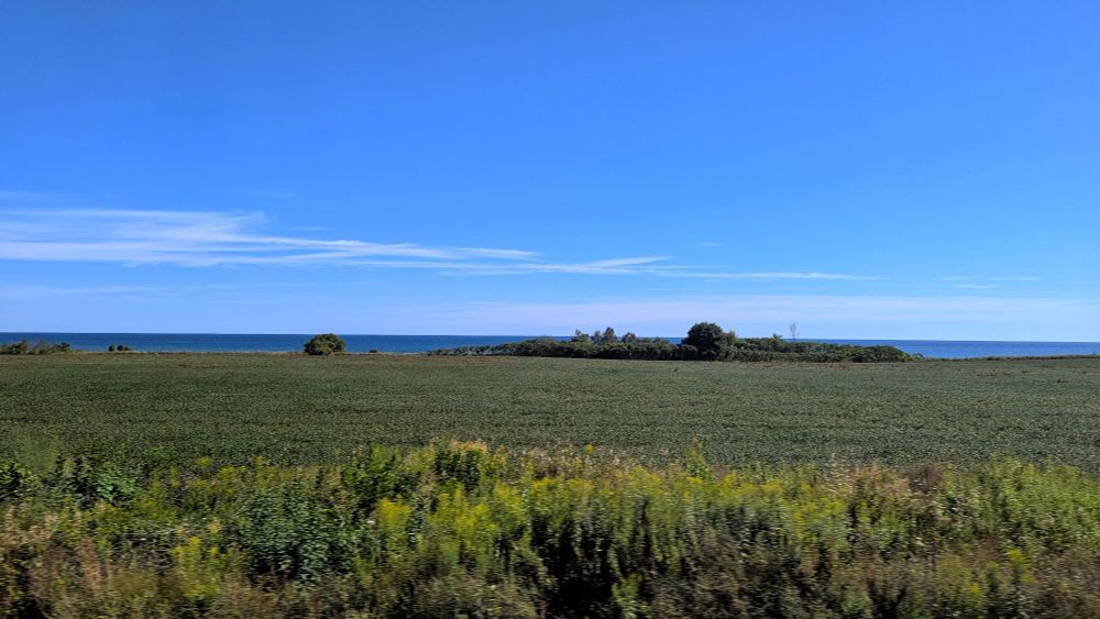 Rural field with Lake Ontario in the background along the Kingston Subdivision near Darlington, Ontario 