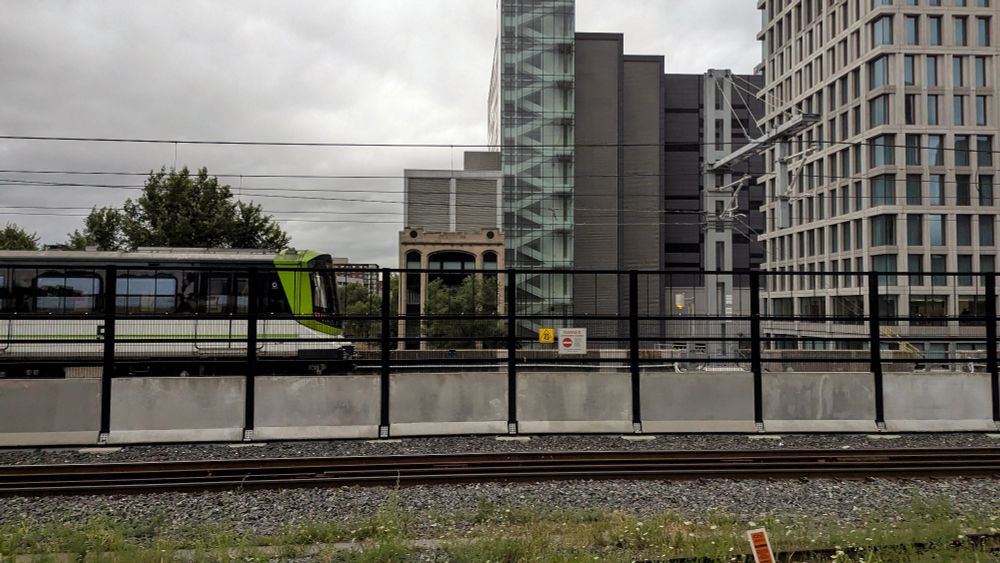 View from a VIA Train outside Gare Centrale, looking west as an REM train passes by. Montreal Quebec 