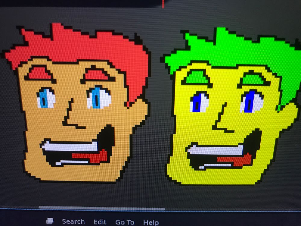Two pixelated faces, one has full saturation green hair, yellow skin, blue eyes, the other has more reasonable colours 