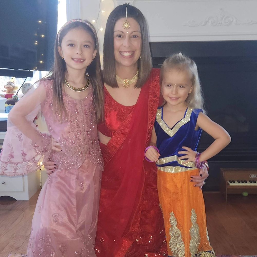 Woman and two girls dressed in Indian clothing for Diwali