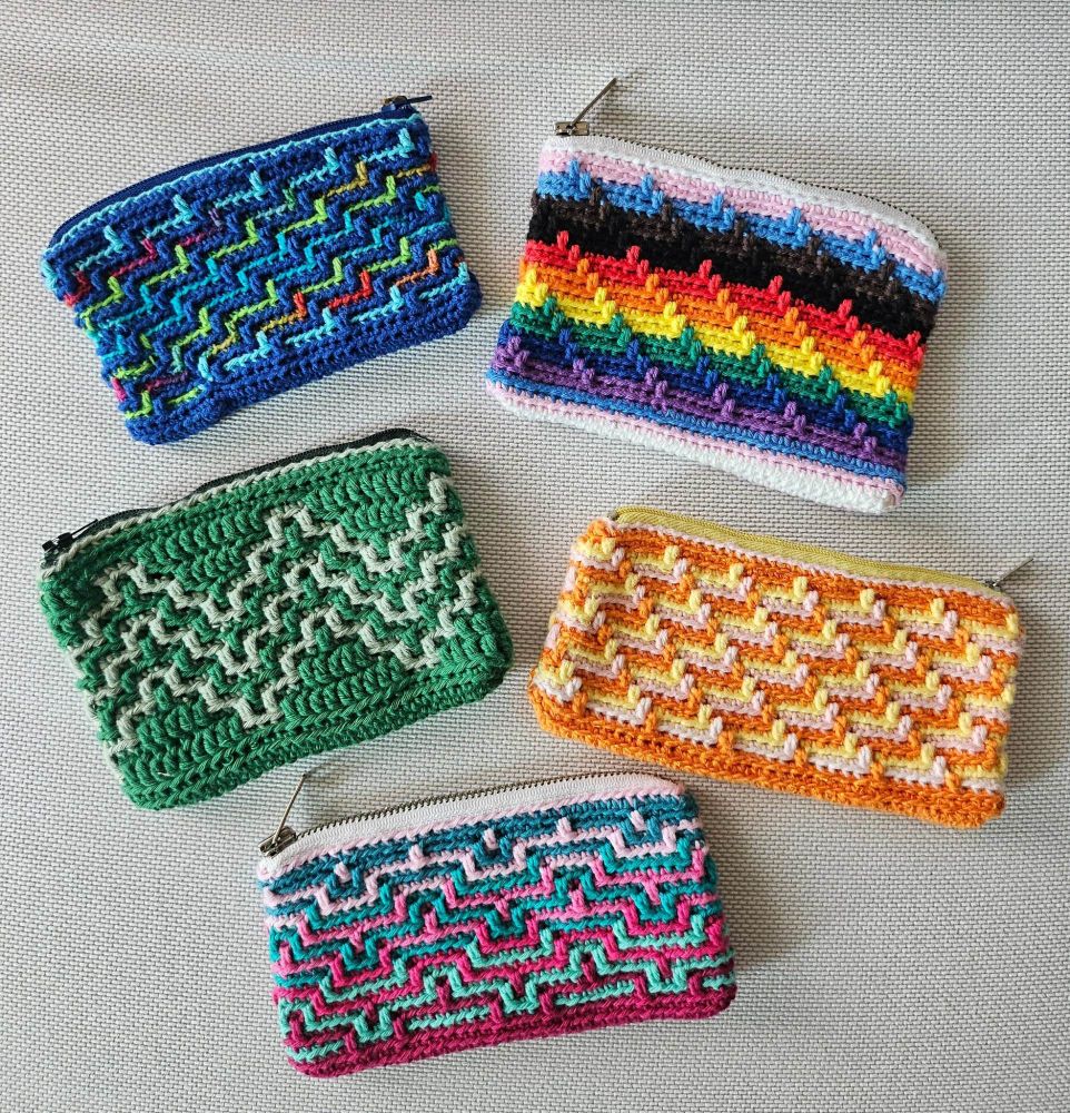 5 crocheted purses with zipper in different patterns and color combinations