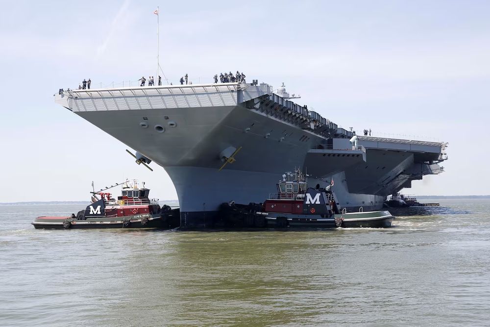 Pre-Commissioning Unit Gerald R. Ford (CVN 78) is maneuvered by tug boats in the James River during the aircraft carrier's turn ship evolution in Newport News, Virginia, U.S. June 11, 2016