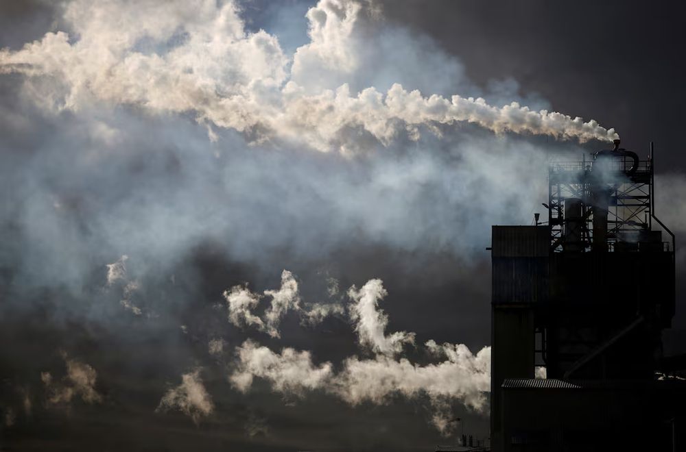 A view shows emissions from the chimneys of Yara France plant in Montoir-de-Bretagne near Saint-Nazaire, France, March 4, 2022. REUTERS/Stephane Mahe 