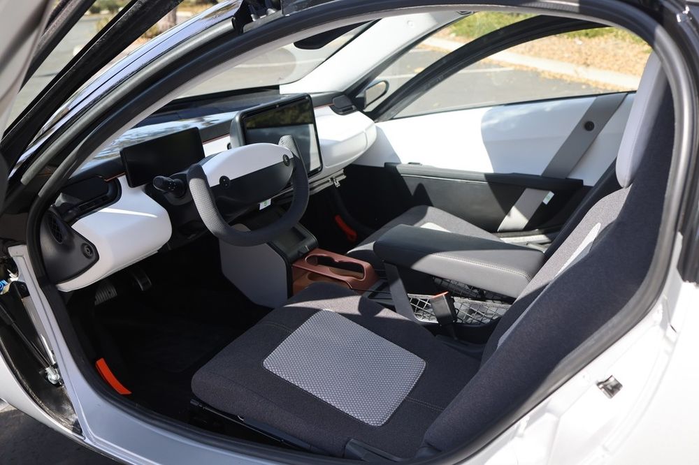 The interior of the Aptera, a solar-powered electric vehicle. The picture shows the front two (and only two) seats.