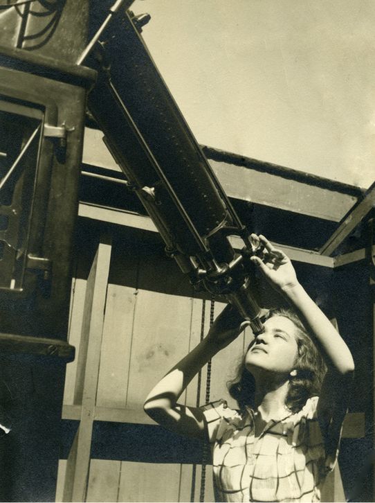 Vera Rubin posing at the eyepiece of the telescope at Vassar College Observatory in 1948. Rubin earned her undergraduate degree from Vassar College that same year. She had been drawn to the institution by its distinguished history of educating women astronomers, beginning with the first female professor of astronomy, Maria Mitchell. Rubin continued her studies at Cornell University for her master’s and Georgetown University for her Ph.D. Credit: Carnegie Science