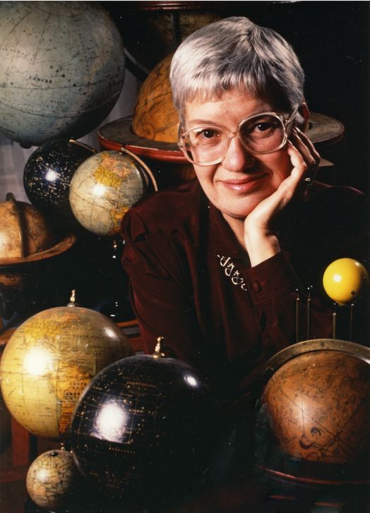Portrait of Vera Rubin in 1989 with a portion of her collection of celestial globes, by photographer Mark Godfrey. Rubin had an avid interest in atlases, star charts, and globes. Her collection began when her astronomy professor at Vassar College offered her an old celestial globe that was about to be discarded. Credit: Photograph by Mark Godfrey, courtesy of Carnegie Science