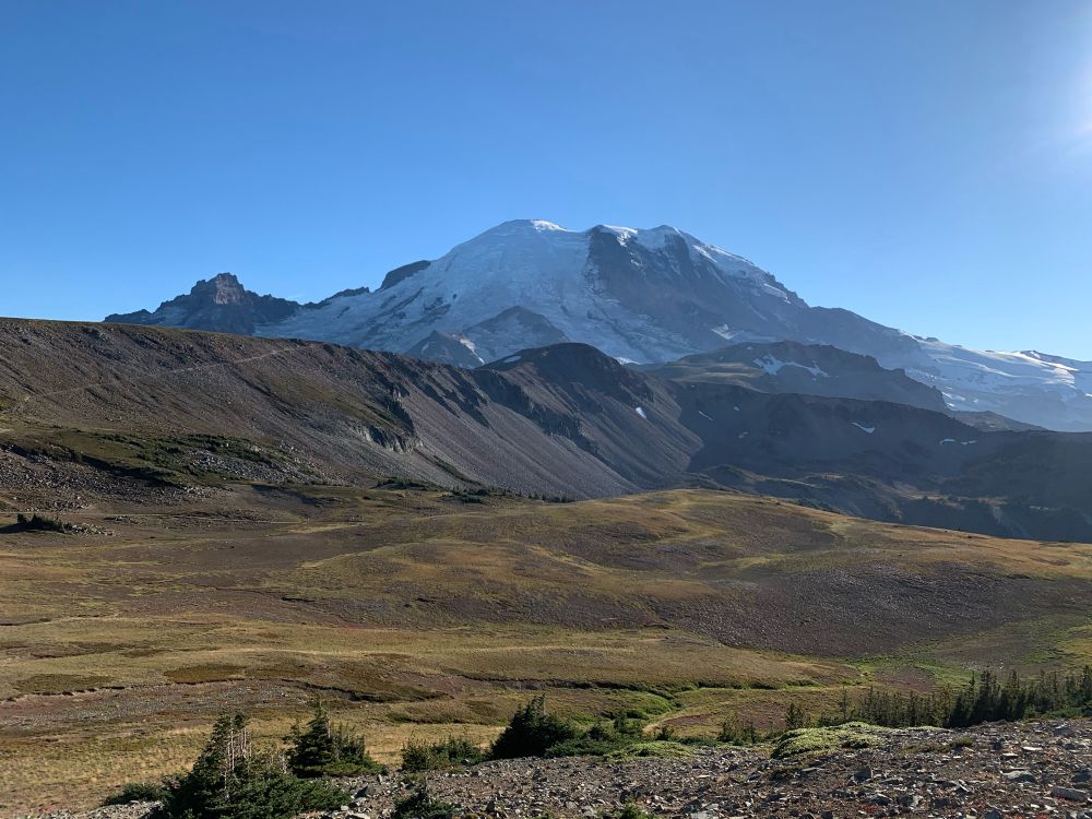 Mt. Rainier from a nearby trail. There are rolling plains in the foreground