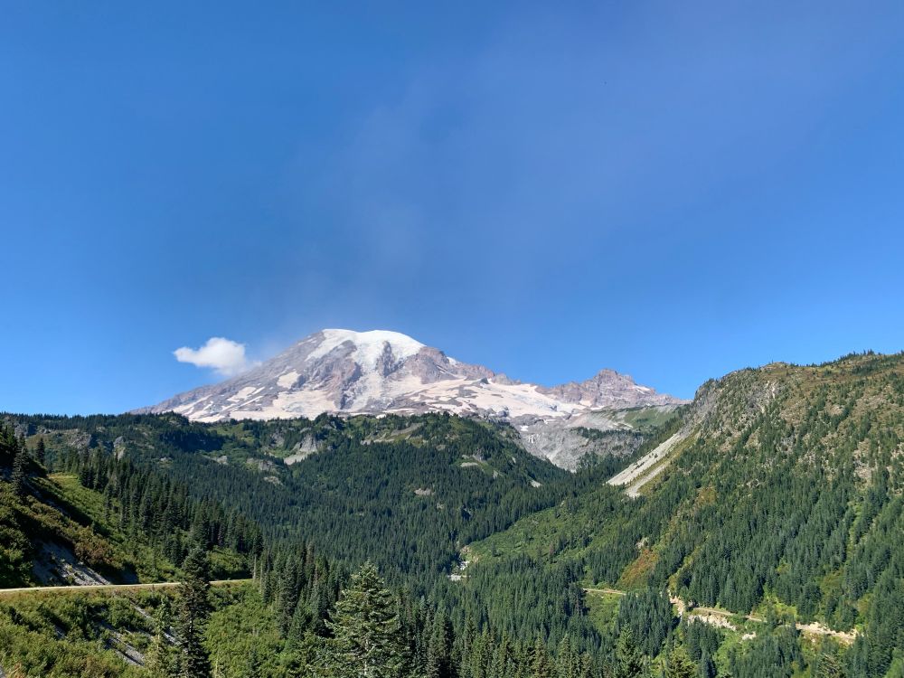 Mt. Rainier from a distance with trees and hills in the foreground